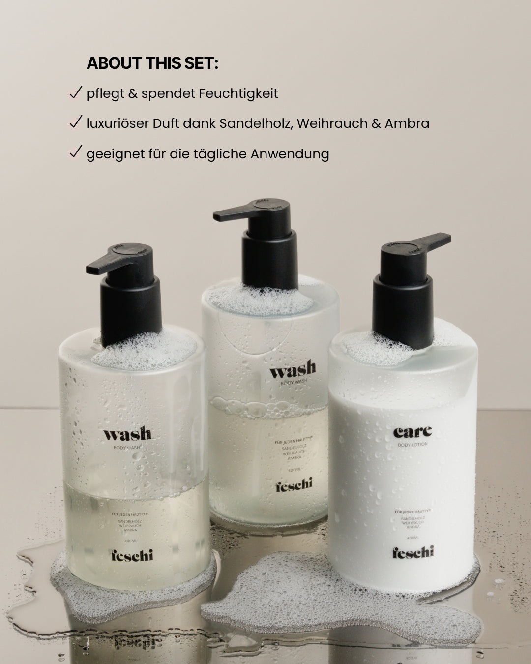 Body Wash und Body Lotion von feschi stehen mit Schaum ummantelt auf Glasplatte