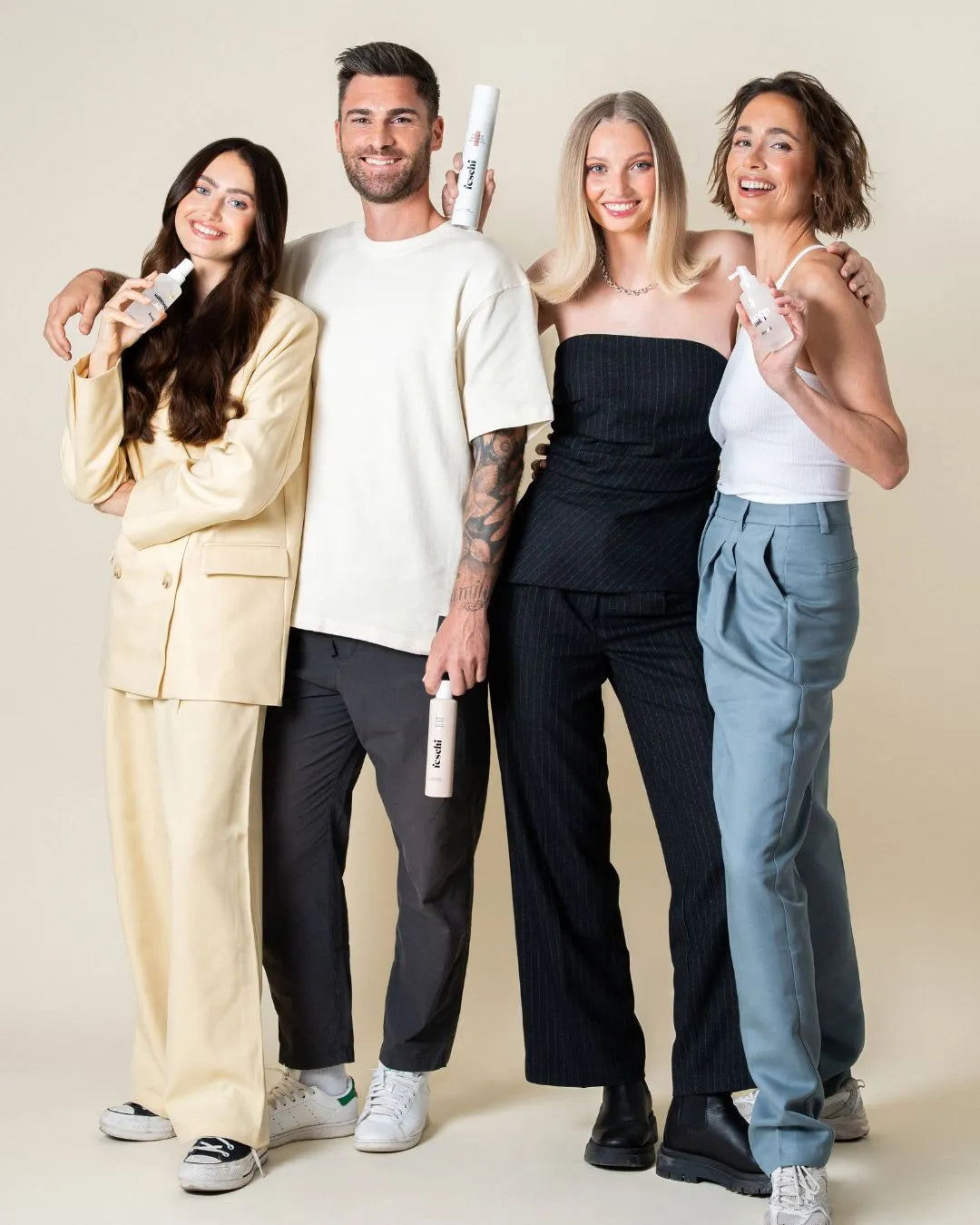 4 Personen stehen nebeneinander und halten jeweils ein feschi Produkt in der Hand